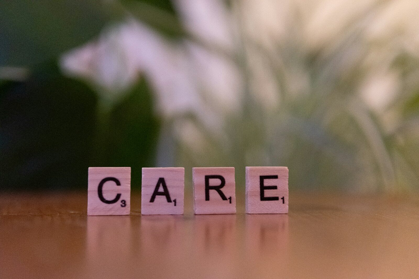 Photo by Markus Winkler A wooden block spelling care on a table